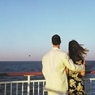 Couple on cruise ship looking at ocean, sunset, rear view

200129496-001